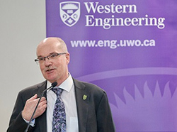 Image of Mike Bartlett speaking with Western Engineering Banner behind him